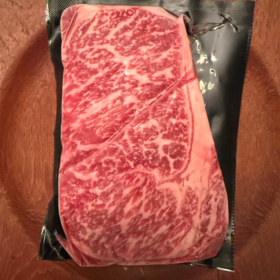 A premium, flash-frozen 100% Fullblood American Wagyu ribeye steak cleanly vacuum-sealed in heavy-duty commercial packaging by Whole Cow.